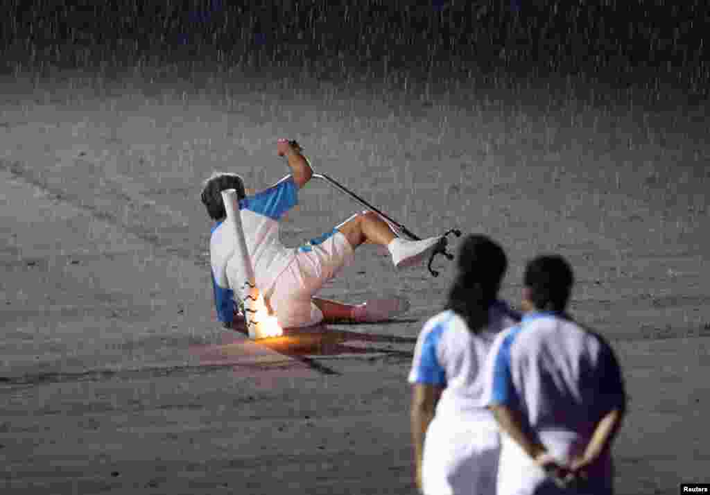 Brazilian Paralympic runner Marcia Malsar falls while carrying the torch during the opening ceremony of the Rio 2016 Paralympic Games at Maracana Stadium in Rio de Janeiro, Brazil, Sept. 7, 2016.
