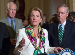 FILE - Sen. Shelly Moore Capito, R-W.Va., with Senate Majority Leader Mitch McConnell of Kentucky, right, and Senate Majority Whip John Cornyn of Texas, speaks to reporters on Capitol Hill in Washington, March 17, 2015.
