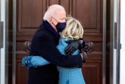 U.S. President Joe Biden and first lady Jill Biden hug as they arrive at the North Portico of the White House in Washington, DC, U.S. January 20, 2021. Alex Brandon/Pool via REUTERS