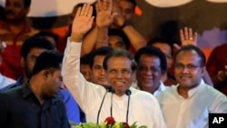 FILE - Sri Lankan President Maithripala Sirisena waves to supporters during a rally outside the parliamentary complex in Colombo, Sri Lanka, Nov. 5, 2018.