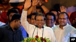 FILE - Sri Lankan President Maithripala Sirisena waves to supporters during a rally outside the parliamentary complex in Colombo, Sri Lanka, Nov. 5, 2018.