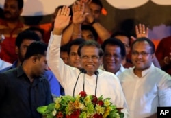 FILE - Sri Lankan President Maithripala Sirisena waves to supporters during a rally outside the parliamentary complex in Colombo, Sri Lanka, Nov. 5, 2018.