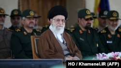 A handout picture released by the official website of the Centre for Preserving and Publishing the Works of Iran's supreme leader Ayatollah Ali Khamenei shows him, center, during a visit to the Imam Hussein Military College in Tehran, May 20, 2015. 