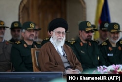 A handout picture released by the official website of the Centre for Preserving and Publishing the Works of Iran's supreme leader Ayatollah Ali Khamenei shows him, center, during a visit to the Imam Hussein Military College in Tehran, May 20, 2015.