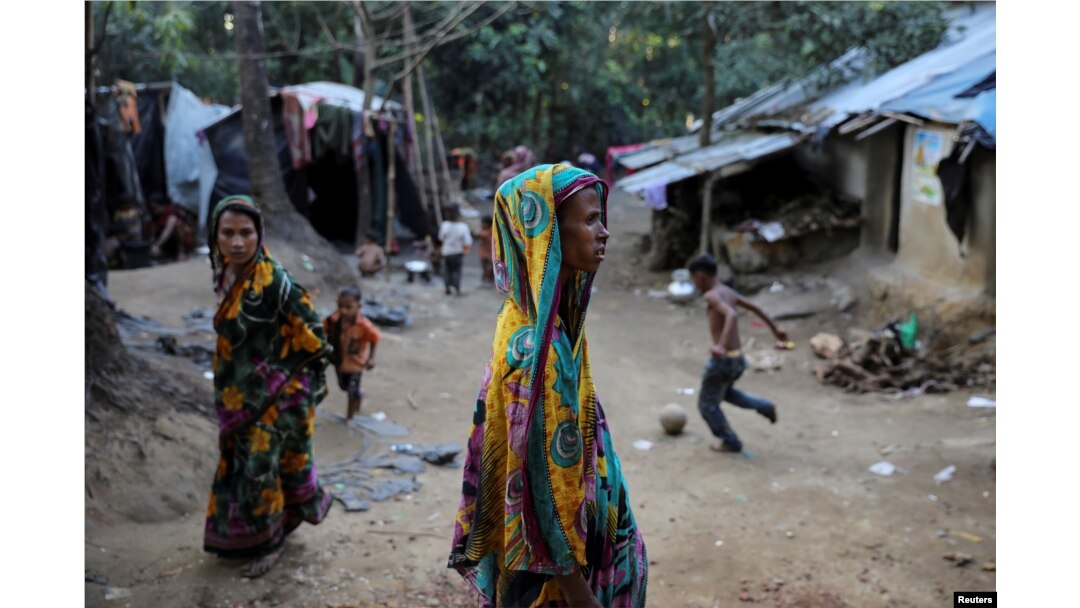 Rohingya Hindu refugees walk through the Kutupalong Hindu refugee camp near Cox's Bazar, Bangladesh, Dec. 17, 2017.