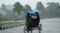 Rickshaw driver plows through heavy rain in Berhampur, about 180 kilometres south of Bhubaneswar, Oct. 12, 2013.