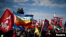 FILE - People attend a demonstration to protest against the loading of weapons aboard a cargo ship operating for Saudi Arabia's defense and interior ministries, in Le Havre, France, May 9, 2019.