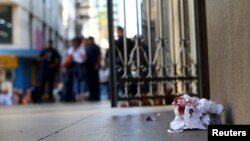 A cloth with blood is seen in front of of the Catholic cathedral where a gunman opened fire to the faithful, in Campinas, Brazil, Dec. 11, 2018 