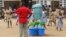 Pupils stand near buckets of water to wash their hands with placed as a preventive measure against Ebola at Anono school in Abidjan Sept. 25, 2014. 