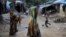 Rohingya Hindu refugees walk through the Kutupalong Hindu refugee camp near Cox's Bazar, Bangladesh, Dec. 17, 2017.