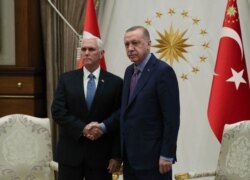 FILE - U.S. Vice President Mike Pence, left, and Turkish President Recep Tayyip Erdogan are pictured at the presidential palace in Ankara, Turkey, Oct. 17, 2019.