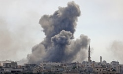 Smoke plumes billow over the Syrian village of al-Nayrab, about 14 kilometers southeast of the city of Idlib, in Syria's northwestern Idlib province, during a bombardment, Feb. 3, 2020.