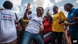 FILE - Women celebrate as their country is declared Ebola-free in Freetown, Sierra Leone, Nov. 7, 2015.