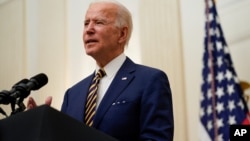 President Joe Biden delivers remarks on the economy in the State Dining Room of the White House, Friday, Jan. 22, 2021, in Washington. (AP Photo/Evan Vucci)