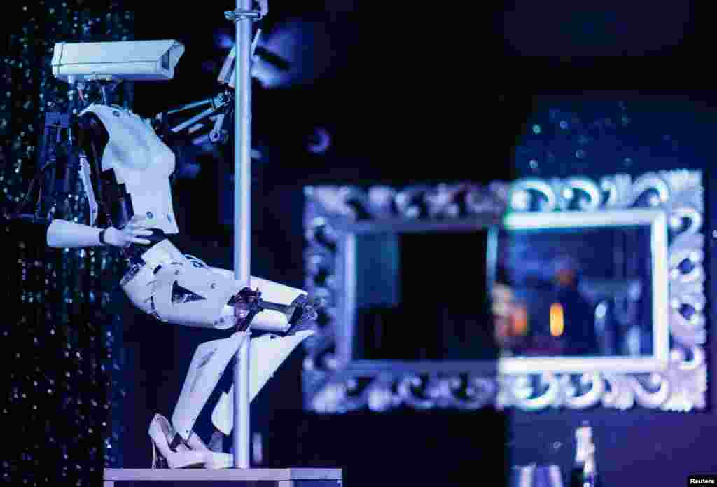 A pole-dancing robot created by British artist Giles Walker is displayed in the Strip Club Cafe in Nantes, France, Aug. 29, 2019.