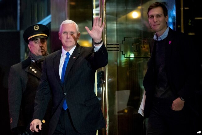 Vice President-elect Mike Pence, second from left, and Jared Kushner, son in-law of President-elect Donald Trump, right, depart Trump Tower, Dec. 7, 2016, in New York.