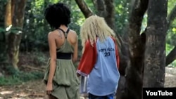 Two women walk side-by-side in a YouTube screen grab from the controversial “Same Love” remix music video by Kenyan recording artists Art Attack and Nicole Florence Kutoto. As of March 17, 2016, the video has had nearly 200,000 views on YouTube.