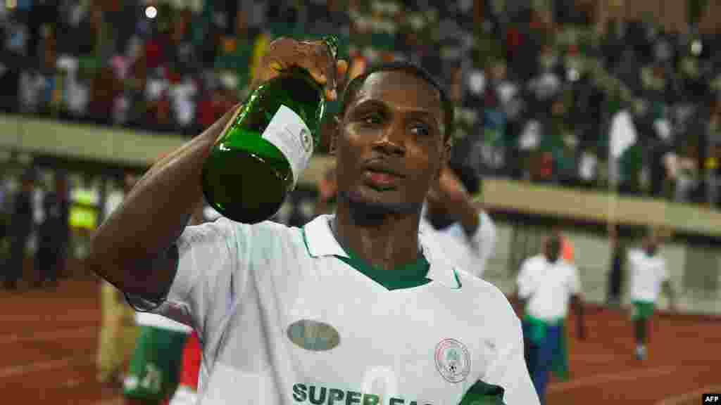 L&#39;attaquant de l&#39;équipe nationale du Nigéria Odion Ighalo boit du champagne alors qu&#39;il célèbre la qualification de l&#39;équipe, Uyo, le 7 octobre 2017.