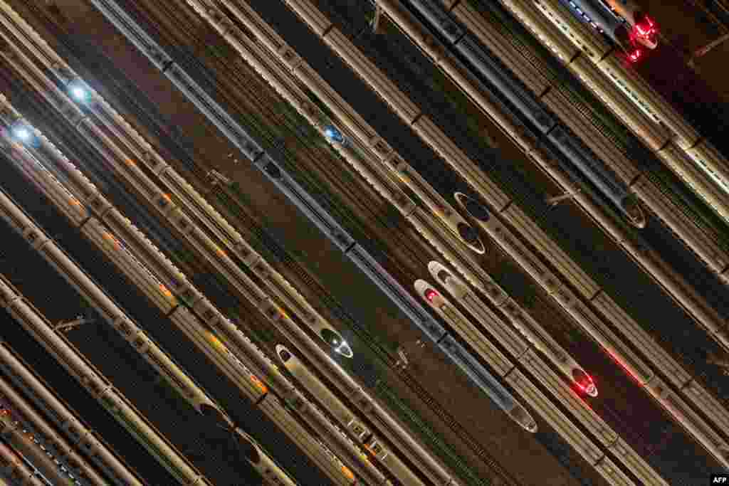 High speed trains are seen outside a maintenance workshop in Nanjing, in China&#39;s eastern Jiangsu province. (Photo by AFP) / China OUT