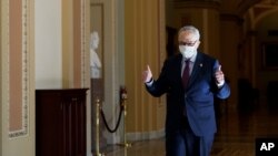 El líder de la mayoría del Senado, Chuck Schumer de Nueva York, levanta el pulgar después de que el Senado aprobó un proyecto de ley de alivio de COVID-19 en Washington, el sábado 6 de marzo de 2021