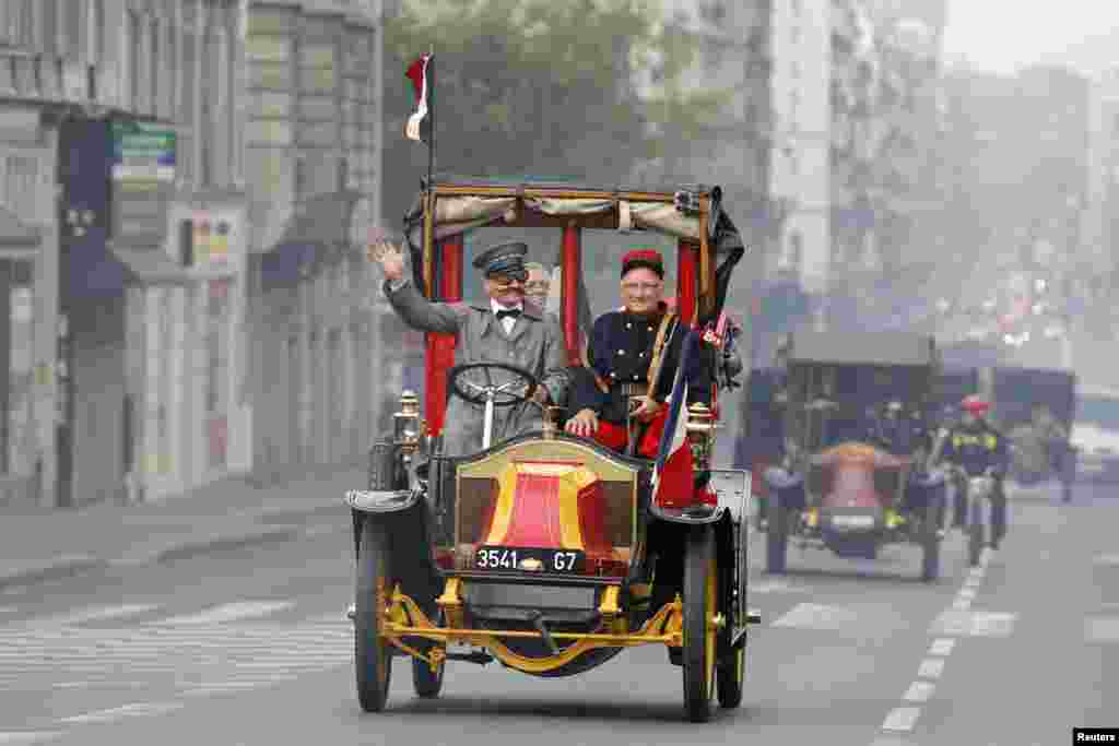 History enthusiasts ride vintage &quot;Taxi de la Marne&quot; during a parade, as part of activities to commemorate the 100th anniversary of the First Battle of the Marne in Paris, France. Parisian taxis were requisitioned by the French Army to transport troops from Paris to the First Battle of the Marne in early September 1914 during WWI.