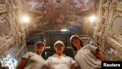 Jose Luis Regidor, restorer and director of the project, joins Pilar Roig Picazo and Pilar Bosch Roig for a picture at the Church of Santos Juanes, in Valencia, Spain, September 16, 2024. (REUTERS/Eva Manez)