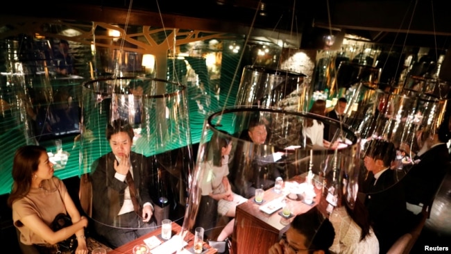 Acrylic screens used as part of measures to prevent the spread of COVID-19 are installed at the Jazz Lounge Encounter, a night club in Tokyo, Japan.
