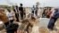 Mourners pray during the burial of a man, who was killed in a fire at a hospital that had been equipped to house coronavirus disease (COVID-19) patients, at a cemetery in Baghdad, Iraq, Apr. 25, 2021. 