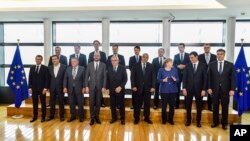European Commission President Jean-Claude Juncker, front center, poses with EU leaders during a group photo at an informal EU summit on migration at EU headquarters in Brussels, June 24, 2018.