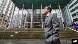 Attorney General Bob Ferguson stands on the steps of the federal courthouse as he waits to speak with media members after an immigration hearing there, March 15, 2017, in Seattle.