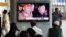 South Korean passengers watch a news reporting about the North Korea's army chief Ri Yong Ho's departure on a TV screen at the Seoul train station in Seoul, South Korea, July 17, 2012.