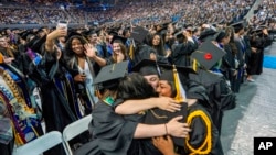 FILE - UCLA students celebrate during a commencement ceremony inside Pauley Pavilion on UCLA campus, in Los Angeles, June 14, 2024.