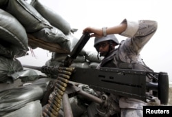 A Saudi soldier loads ammunition from a position at Saudi Arabia's border with Yemen, April 6, 2015.