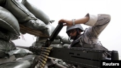 A Saudi soldier loads ammunition at their position at Saudi Arabia's border with Yemen, April 6, 2015. 