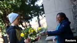 Residents collect posies to hand out for Mother's Day outside St Leonard’s Church for Mother's Day as the spread of the coronavirus disease (COVID-19) continues, Streatham, London, March 22, 2020.