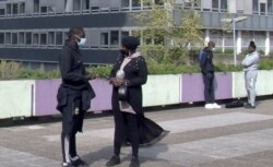 Aboubacar N'diaye, left, helped launch a youth group in the Paris suburb of Bobigny. He says police profiling is something that could happen to him. (Lisa Bryant/VOA)