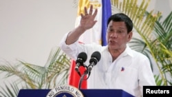 FILE - Philippine President Rodrigo Duterte gestures while answering questions during a news conference upon his arrival from a state visit in Japan at the Davao International Airport in Davao city, Philippines October 27, 2016. 