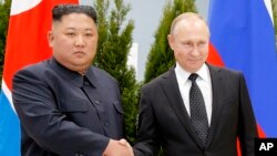 Russian President Vladimir Putin, right, and North Korea's leader Kim Jong Un shake hands during their meeting in Vladivostok, Russia, Thursday, April 25, 2019.