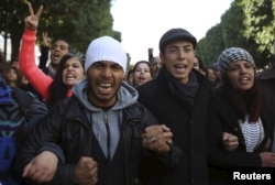 Unemployed graduates shout slogans during a demonstration to demand the government provide them with job opportunities, on Habib Bourguiba Avenue in Tunis, Tunisia, Jan. 20, 2016.