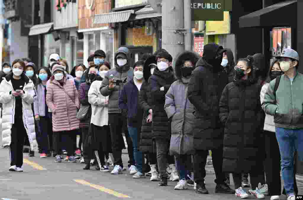 People wait in line to buy face masks at a store in the Dongseongro shopping district in Daegu, South Korea. South Korea reported 334 new coronavirus cases, taking its total to 1,595, still the largest in the world outside China, where the disease first began.