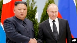 Russian President Vladimir Putin, right, and North Korea's leader Kim Jong Un shake hands during their meeting in Vladivostok, Russia, Thursday, April 25, 2019.