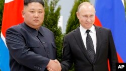 Russian President Vladimir Putin, right, and North Korea's leader Kim Jong Un shake hands during their meeting in Vladivostok, Russia, Thursday, April 25, 2019.