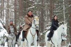 FILE - North Korean leader Kim Jong Un, center, rides a horse as he visits battle sites at Mount Paektu, Ryanggang, in this undated picture released from North Korea's official Korean Central News Agency (KCNA) on Dec. 4, 2019.