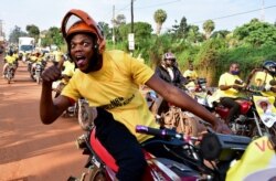 Supporters of Uganda's National Resistance Movement celebrate the victory of President Yoweri Museveni in the concluded general elections in Kampala, Uganda, Jan. 16, 2021.