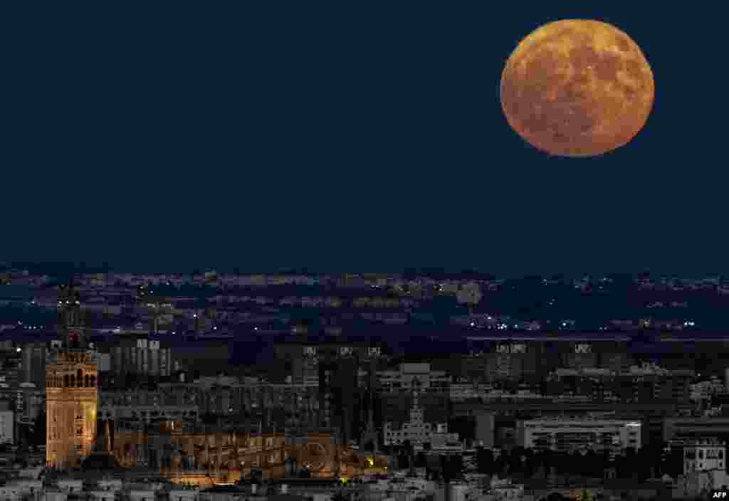 The full moon rises over the cathedral of Seville, Spain, on Aug. 19, 2024.