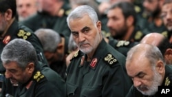 FILE - In this photo provided by an official website of the office of the Iranian supreme leader, Revolutionary Guard Gen. Qassem Soleimani, center, attends a meeting in Tehran, Iran, Sept. 18, 2016.