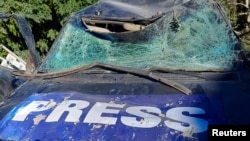 A damaged vehicle marked with 'Press' is seen at the site of an Israeli strike that killed a few journalists and wounded several others, Lebanon's health ministry and local media reported, in Hasbaya in southern Lebanon, Oct. 25, 2024.