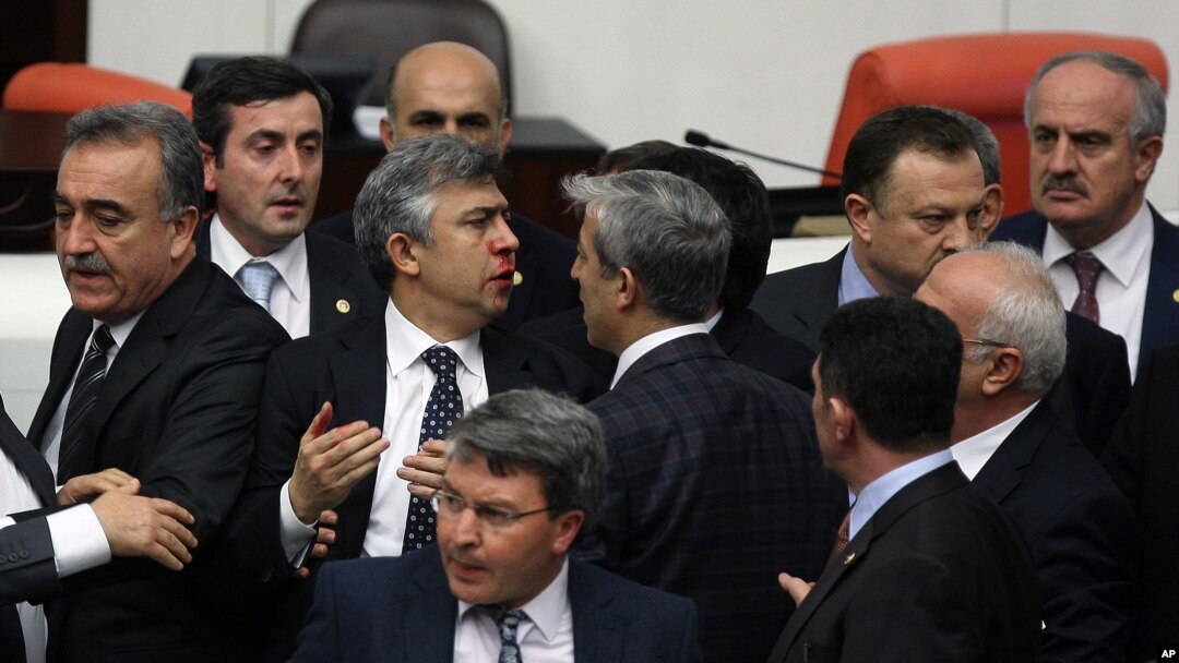 FILE - Turkish legislators from Prime Minister Recep Tayyip Erdogan's ruling party and the main opposition Republican People's Party brawl during a tense all-night debate over a controversial law on changes to a council that appoints and overseas judges a
