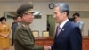 In this photo provided by the South Korean Unification Ministry, South Korean presidential security adviser Kim Kwan-jin, right, shakes hands with Hwang Pyong So, North Korea's top political officer for the Korean People's Army, after their meeting at the