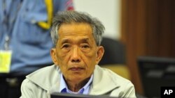 Kaing Guek Eav, alias Duch, gestures in the Extraordinary Chambers in the Courts of Cambodia on the outskirts of Phnom Penh, March 29, 2011